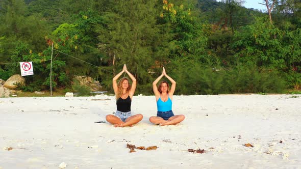 Beautiful women best friends on luxury coast beach trip by blue ocean with white sandy background of