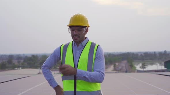 Aerial top view of engineer man or worker,people, with solar panels or solar cells on the roof