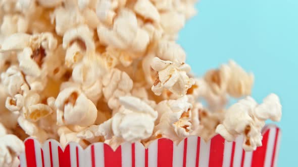 Falling Popcorn in Super Slow Motion on Blue Background