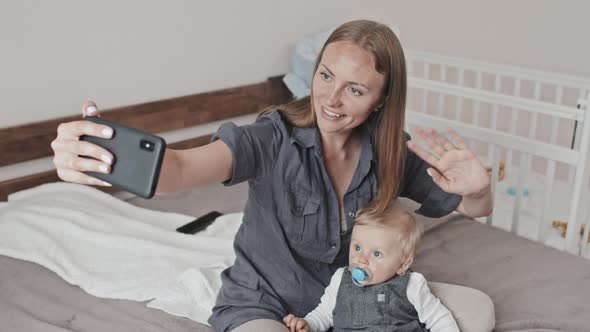 Woman with Son Video Calling in Bedroom