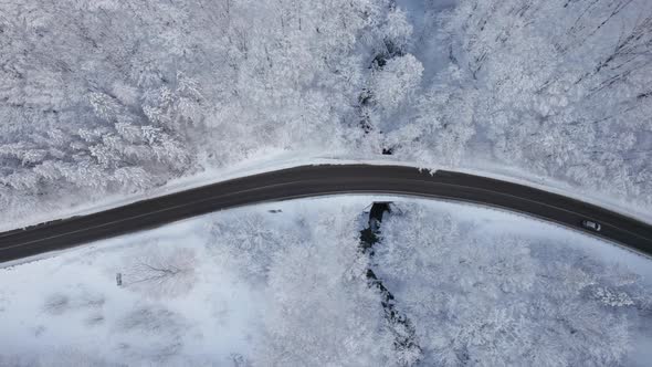 Aerial Top Down Cinematic Winter Snow Cowered Country Road Asphalt Serpentine