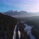 Aerial view of mountain twisted road in the winter and driving car. Cinematic drone shot - VideoHive Item for Sale