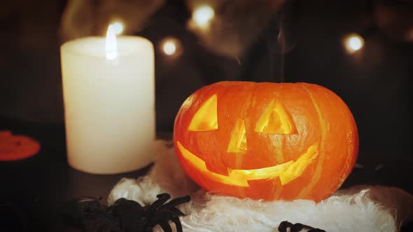 Lighting carved pumpkin on dark background. Halloween concept.