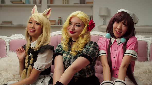 Portrait of Charming Multicultural Female Cosplayers in Costumes Posing Indoors