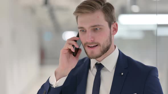 Aggressive Young Businessman Angry on Smartphone