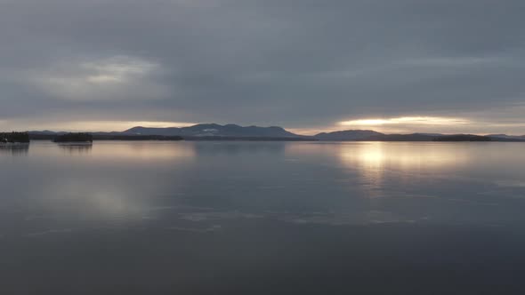 Spectacular aerial view of ice forming on Moosehead lake at golden hour