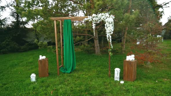 Green Fabric on a Wedding Arch Flutters in the Wind in Slow Motion