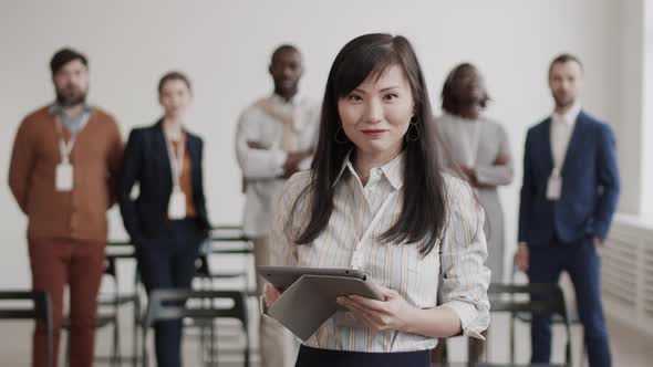 Asian Businesswoman Posing with Tablet Computer