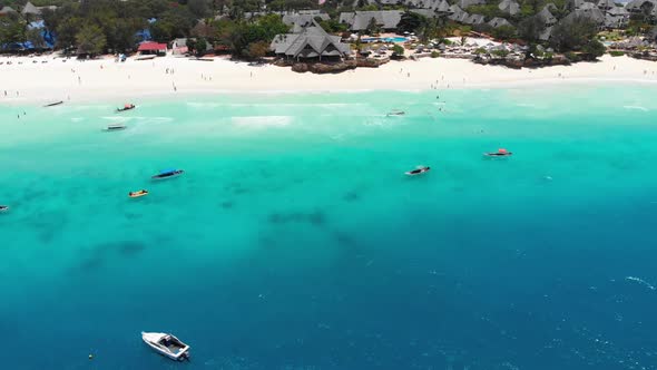 Exotic Sandy Beach with Turquoise Ocean Boats and Hotels Zanzibar Aerial View