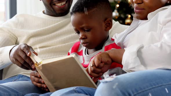 African Family Reading Book on Christmas at Home
