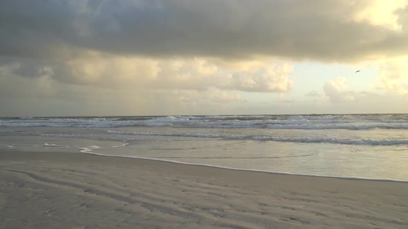 Waves splashing on the beach at high tide during sunrise at the Atlantic Ocean Central Florida