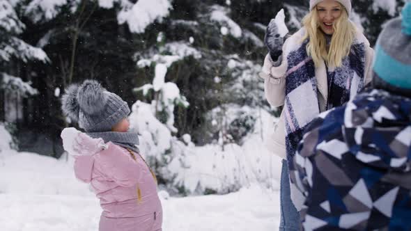 Video of family having a snowball fight in the snow. Shot with RED helium camera in 8K.