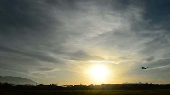 Airplane Passing and Arriving at Sunset