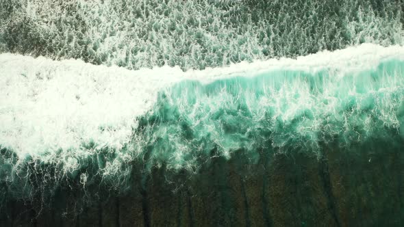 Tropical overhead clean view of a sandy white paradise beach and aqua turquoise water background in 