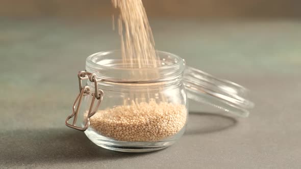White raw quinoa in glass jar