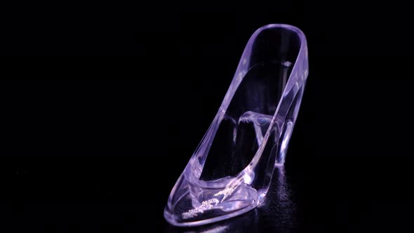 Rotating Crystal or Transparent Glass Slipper on Black Background Cinderella Concept