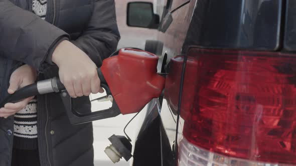 A Woman Fills Up Her Car