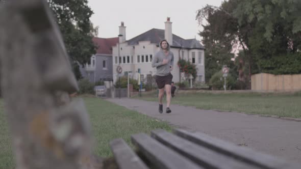 Young Athletic Man Goes for Run In The Park - Ungraded