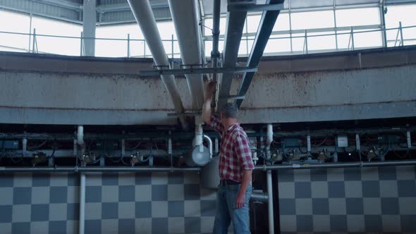 Farmer Checking Milking Platform at Countryside