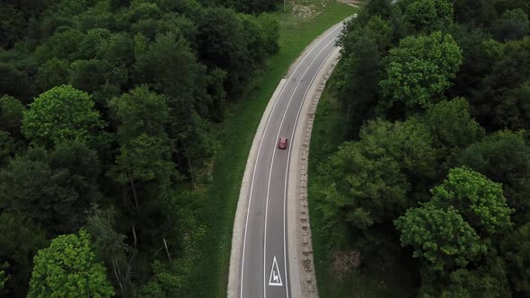 Drone Point of View Tracking Mode Aerial View Flying Over Two Lane Countryside Forest Road with