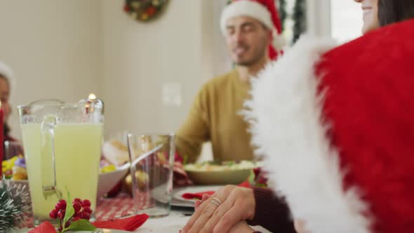 Focused caucasian family praying together before christmas dinner