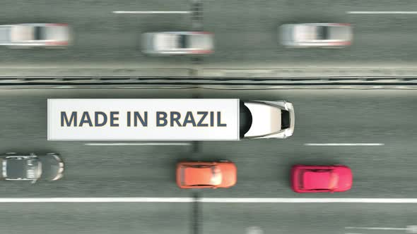 Trailer Trucks with MADE IN BRAZIL Text Driving Along the Highway alt