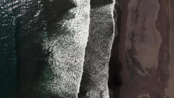 Top Down Aerial View of Giant Ocean Waves Crashing and Foaming