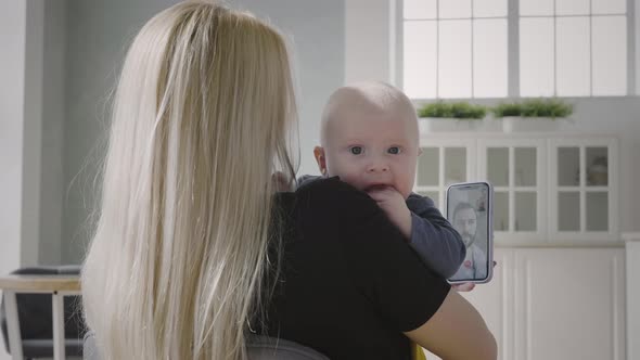 Mother with baby son have video chat