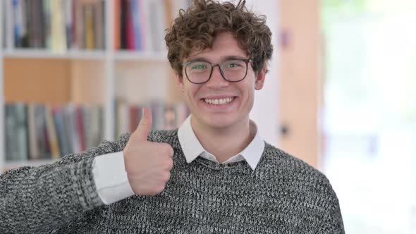 Portrait of Positive Young Man with Thumbs Up