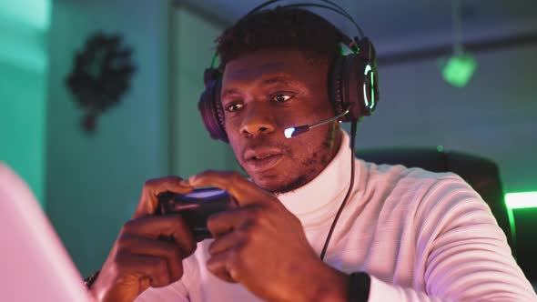 Portrait Shot of Focused Young Black Man Professional Game Player Playing Video Games