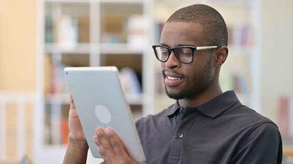 Portrait of Ambitious Young African Man Using Tablet