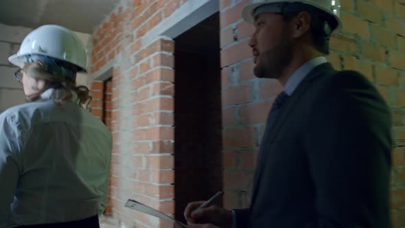 Construction Contractor Showing Unfinished Building alt