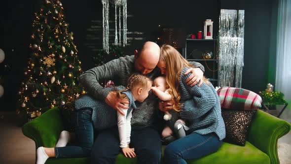 Christmas Concept - Happy Family Sitting on the Couch and Having Fun