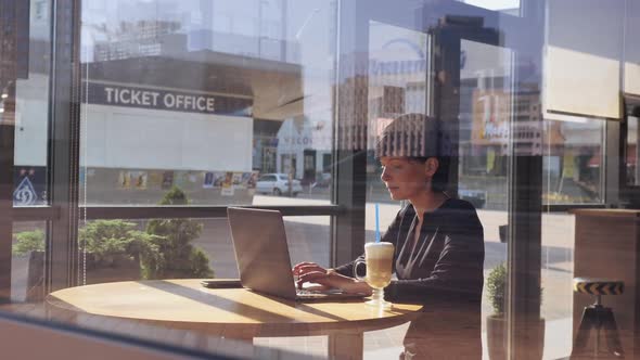 Young Brunette Enjoy Morning Coffee in Cafe Using Laptop