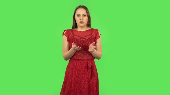 Tender Girl in Red Dress Is Listening To Information, Shocked and Very Upset. Green Screen
