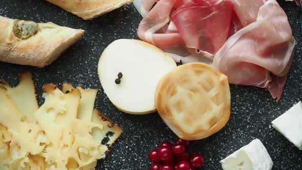 Cold appetizer. Cold cuts. Spicy food on black background. 