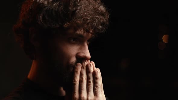 Closeup Face of Nervous Bearded Young Man Reading Online Message While Looking at Laptop Screen