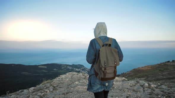 Woman Traveler with Backpack Walking and Enjoying View at Mountains