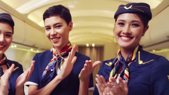 Cabin Crew Clapping Hands in Airplane