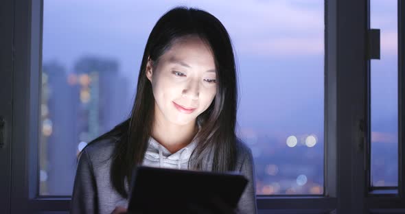 Woman use of tablet computer at night 