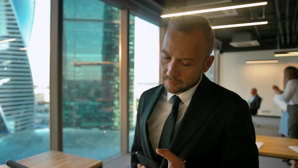 Attractive Handsome Boss in Office Openspace Typing and Chatting with His Deal Partner