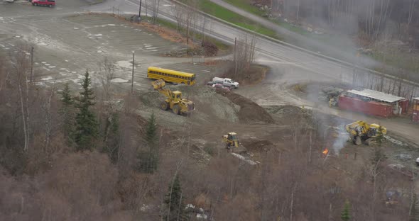 Helicopter aerial shot zooming in on airport parking lot next to freeway, foggy day