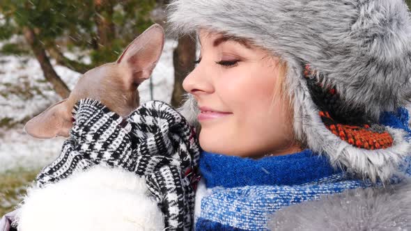 Woman Playing With Dog Outside. Winter