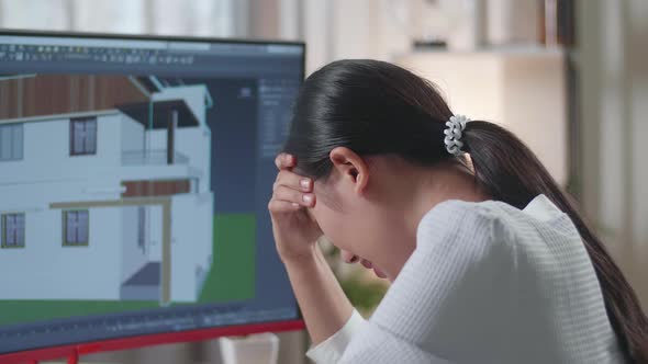 Close Up Of Asian Woman Engineer Having A Headache While Designing House On A Desktop At Home