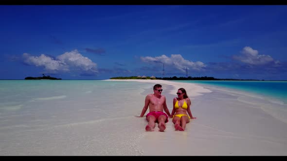 Boy and girl suntan on exotic shore beach adventure by shallow ocean and white sand background of th