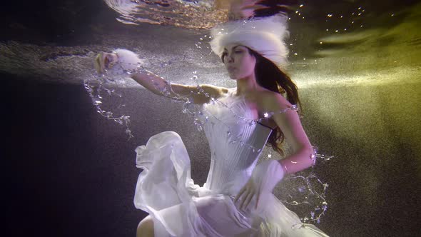 Magic and Romantic Woman Is Wearing Suit of Christmas Fairy Is Floating Underwater