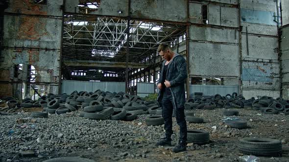 Man standing in ruined building. Young man posing in abandoned building