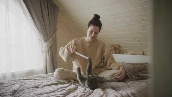 A young girl in beige clothes plays