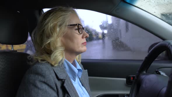 Tired Aged Business Lady Sitting in Car, Big City Exhaustion, Traffic Jam Stress