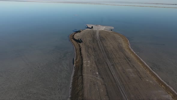 A drone shot flying over the Bonneville Salt Flats shows the Salt Flats causeway dividing the floode